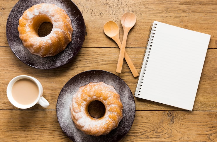 Homemade donuts served on a tray with tea and milk for family breakfast.