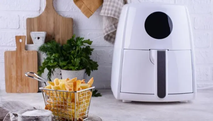 Inside view of an air fryer showing the top heating elements and fan mechanism
